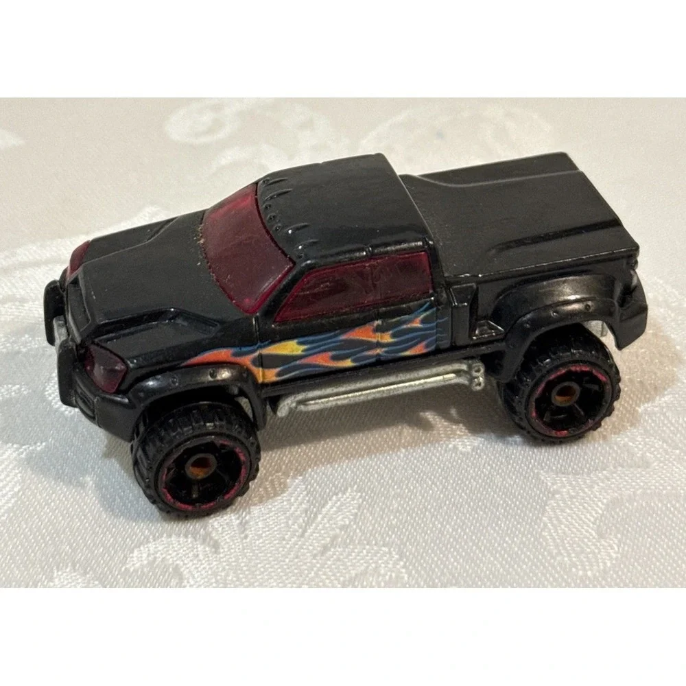 Hot Wheels Mega Duty black pickup truck, specifically the 2010 Heat Fleet